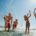 Group of people splashing in the sea