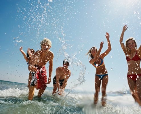 Group of people splashing in the sea
